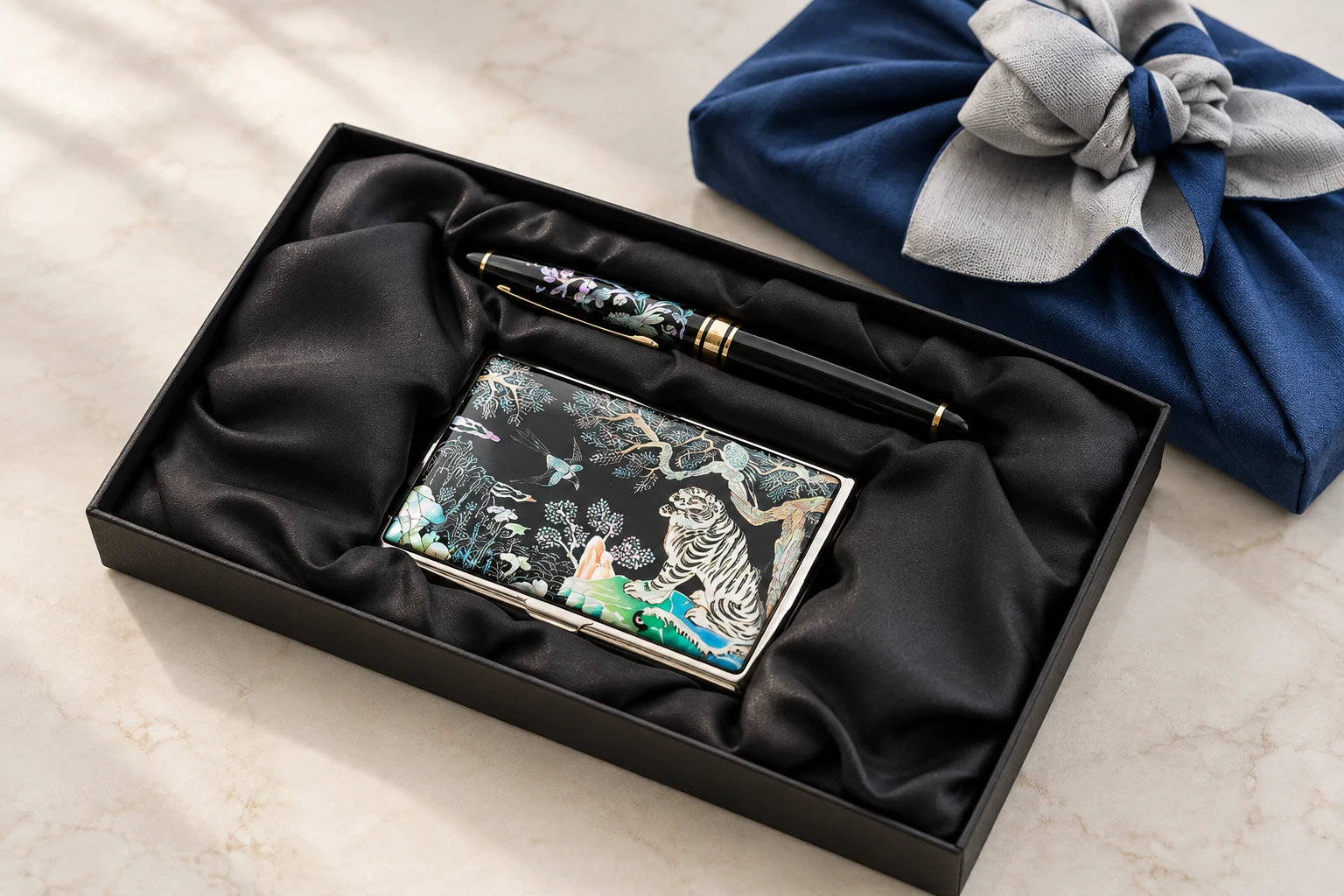 Mother-of-pearl card case and matching pen together in a black gift box. Optional presentation concept.