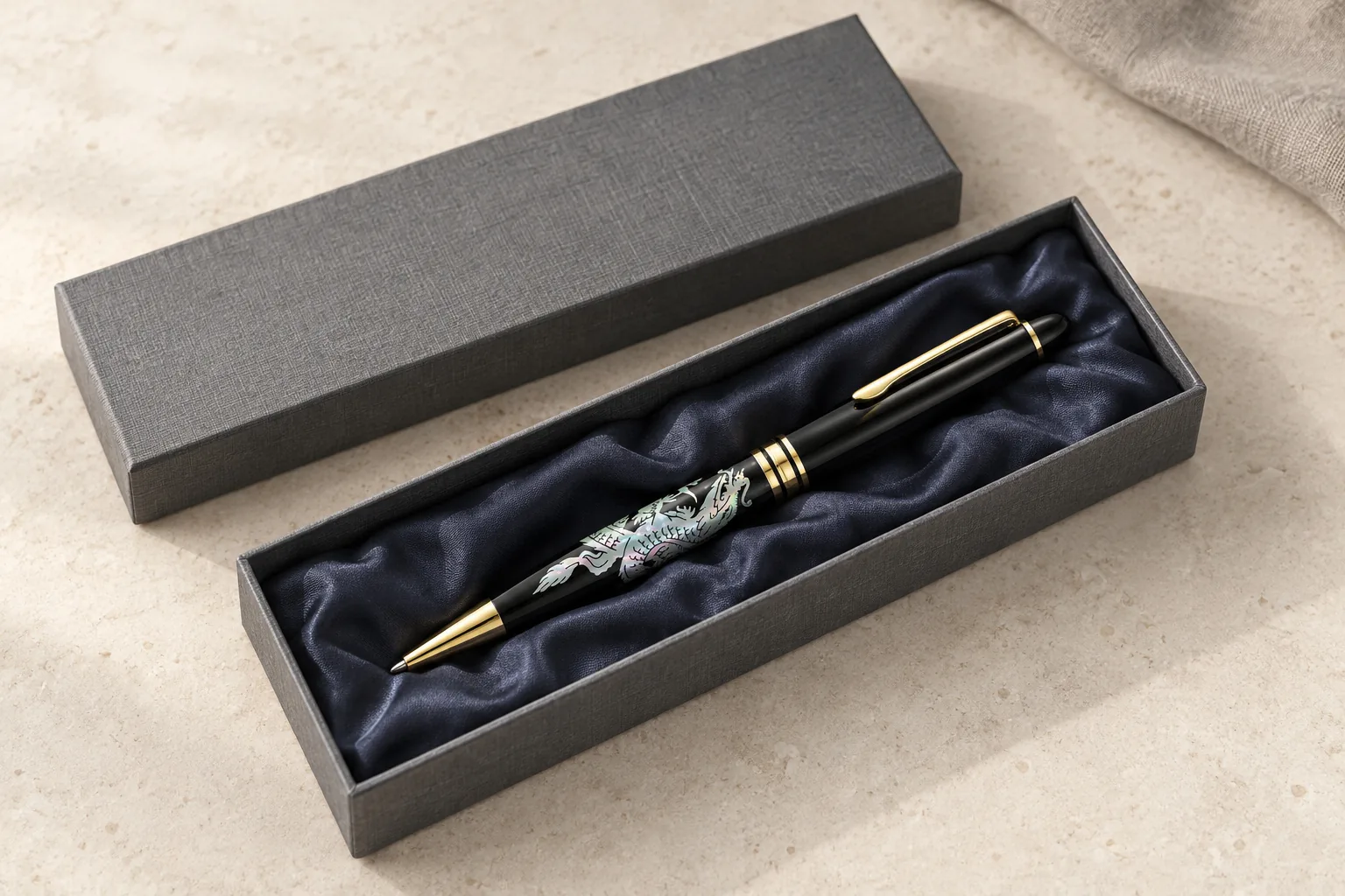 Mother-of-pearl pen in an open grey textured case lined with navy satin. Design concept.